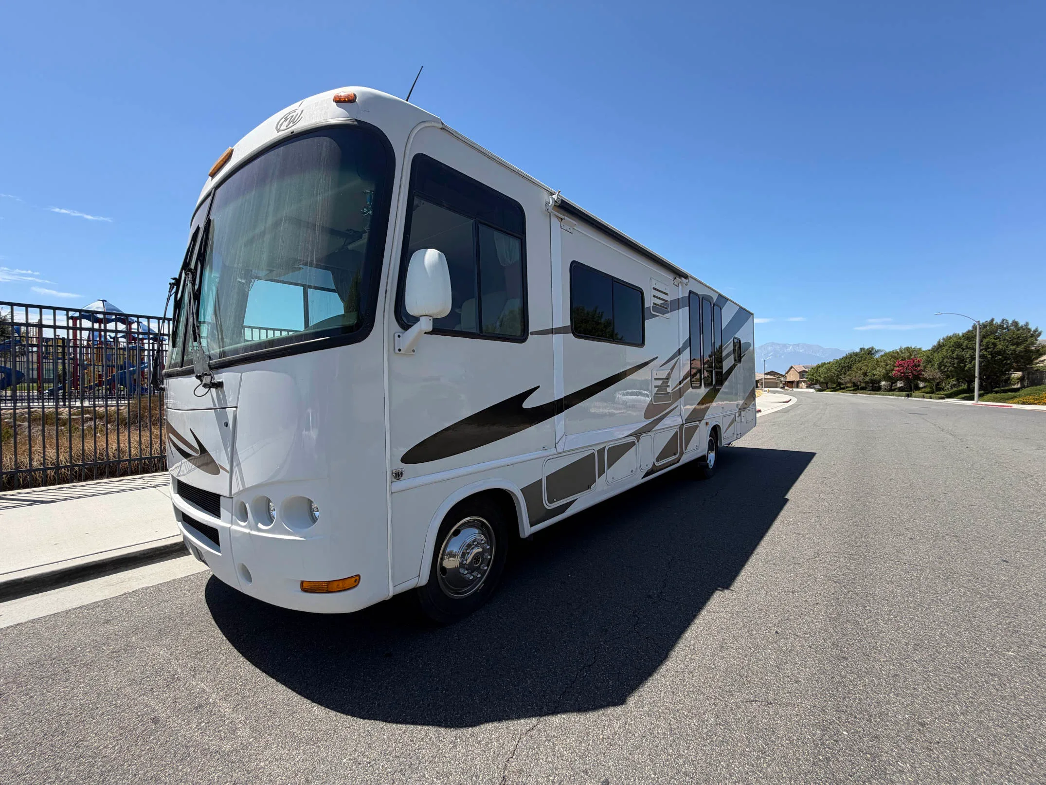 SEO Alt Text: 2007 Four Winds Class A motorhome parked along a Southern California suburban street
